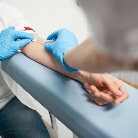 doctor is collecting blood sample of the patient